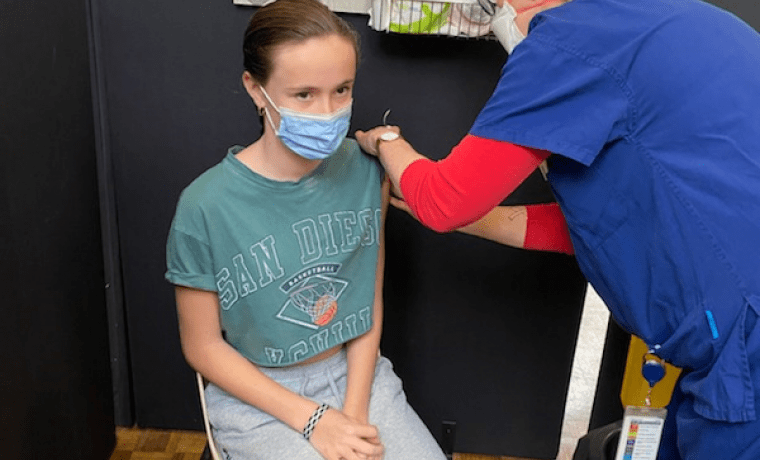 Lila Switzer, 13, receives the 20,000th vaccine to be administered at the Community Vaccination Clinic at Wonthaggi Town Hall from Clinic Manager, Alice Bradley, on Friday.