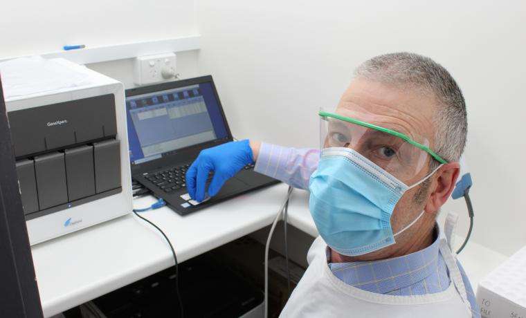 Stephen Griffiths, Monash Health Pathology’s Manager at the Wonthaggi Laboratory, demonstrates the Rapid COVID-19 testing analyser in action.