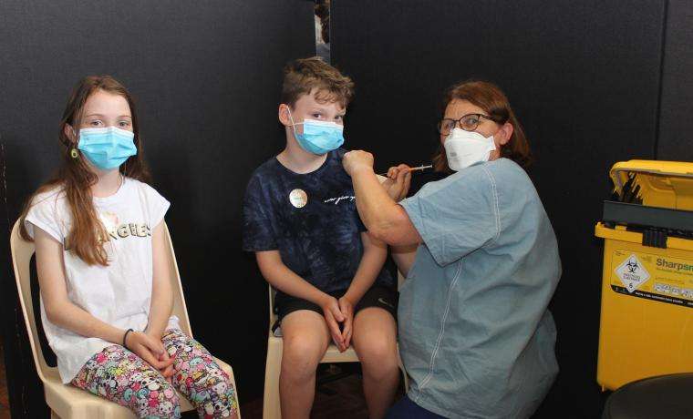 Nurse Immuniser Trudy Foon vaccinates Zoe and Archie Kiernan at the Wonthaggi Town Hall ahead of school returning.