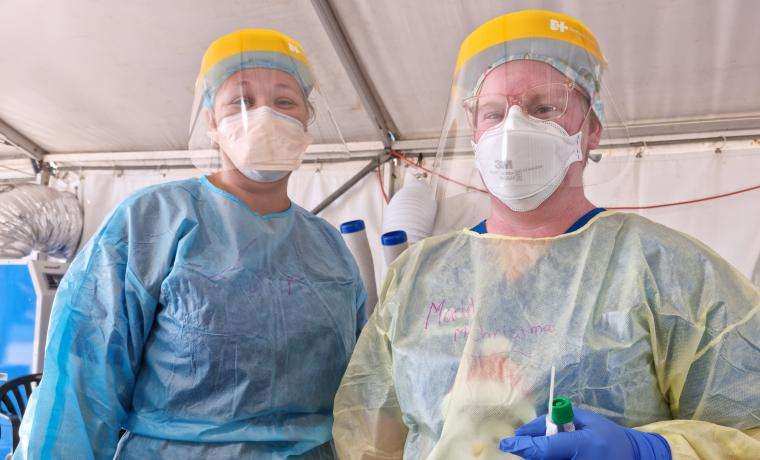 Wonthaggi testing staff Laura Mathieson (left) and Maddie Patullo are among the Bass Coast Health staff wearing full personal protective equipment in hot conditions to help minimise the spread of COVID-19 in our community.