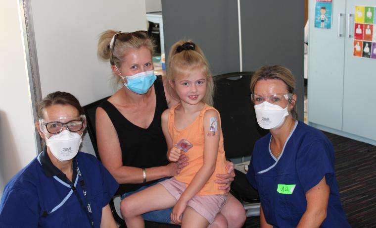 Hope Poulton was vaccinated at Bass Valley Children’s Centre. She is with her mother Chantelle and Immunisation Nurses Mary Sylvester, left and Mel Heber.
