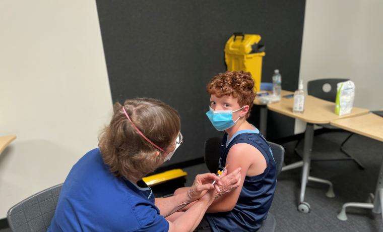 Ziggy Wagner receives his COVID vaccination from Bass Coast Health Immunisation Nurse Moira Jeavons.