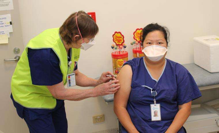 Bass Coast Health Nurse Immuniser Cindy Munro (right) receives a flu vaccination from Nurse Immuniser Moira Jeavons. [