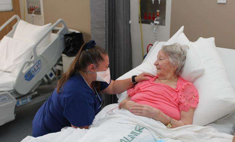 Acute Ward Associate Nurse Unit Manager Randy Thompson chats with patient Hazel McGlone at Wonthaggi Hospital.
