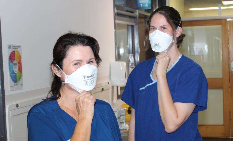 Nurses Deb Allen-Ryan (left) and Steph Kolb demonstrate the wearing of N95 masks on Sub-Acute Ward at Wonthaggi Hospital. The masks have been critical to eliminating COVID transmission within the workplace.