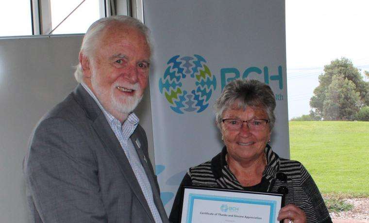 Bass Coast Health Board Chair Don Paproth presents an award to volunteer Julie Kilgour in recognition of her 40 years of service to the organisation.