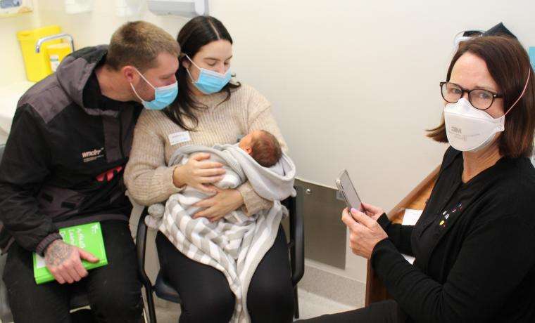 Denise Lawlor of GenV consults new parents Candin Willet and Rhys Horstman, and their son Jack Horstman, at Wonthaggi Hospital as part of the GenV research project.