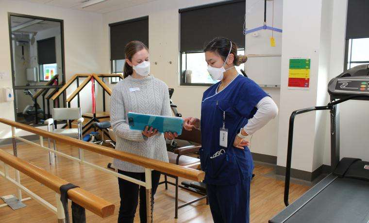 Clinical Development Physiotherapist Dr Cassie McDonald discusses a rehabilitation program with Physiotherapist Annabelle Fong at Wonthaggi Hospital.