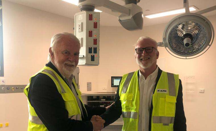 Outgoing Bass Coast Health Board Chair Don Paproth (left) wishes incoming chair Ian Thompson well in a new theatre in the Wonthaggi Hospital Expansion.