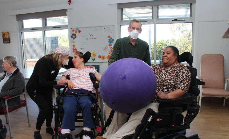 NDIS residents at Kirrak House aged care facility in Wonthaggi, Kristy Maclean, left, and Betty Pitts, with Endorsed Enrolled Nurse Naomi Johnston and Diversional Therapist Trevor Howard, enjoy an exercise session.