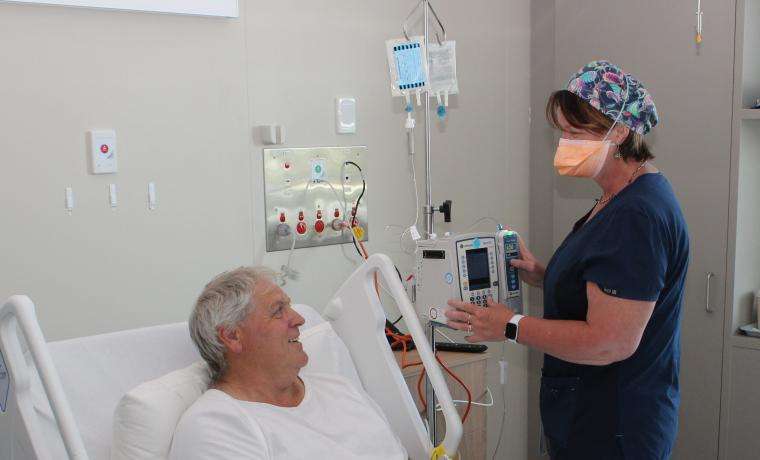 Registered Nurse Carrie Grieve assists patient Mark Scott, who thinks the new ward is so wonderful that Bass Coast Health will have difficulty getting patients to leave.