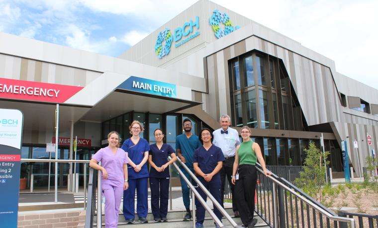 Interns from Monash Health on the steps of the new Wonthaggi Hospital. From left, Anastasia Stenos, Lauren Wright Hill, Jessica Hinh, Vikram Amara and Dan Zou with BCH Clinical Dean Assoc. Prof. Bruce Waxman and Sophie Henderson from BCH’s Medical Workforce team.