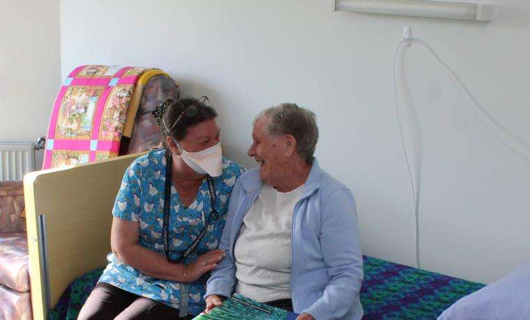 Griffiths Point Lodge Associate Nurse Unit Manager Anne Drennan shares a jovial moment with resident Ronda Schubert in a newly renovated room.