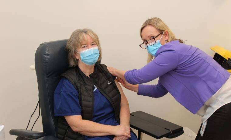Bass Coast Health Infection Prevention and Control Nurse Kylie Lambert gives a flu vaccination to Chronic Disease Management Clinical Nurse Consultant Carolyn Thatcher.