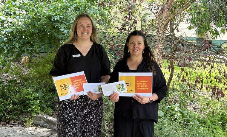 Beth (Health Promotion Officer, South Coast Prevention Team) presenting Hayley (OSHC Coordinator, Loch Primary School) with vouchers for their efforts in Vic Kids Eat Well. 