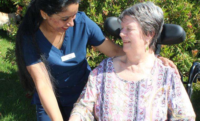 Acting Kirrak House Nurse Unit Manager Deepa Ipe chats with resident Ann Bolding.