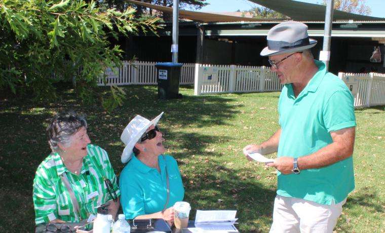 Phillip Island Health Hub Auxiliary Committee Member Louanne Caldwell and Secretary Gill Scrase sell a raffle ticket to Darrell Silva of The Big Wave Complex at Newhaven, during the St Patrick’s Day Picnic Race Day at Woolamai and District Racing Club.