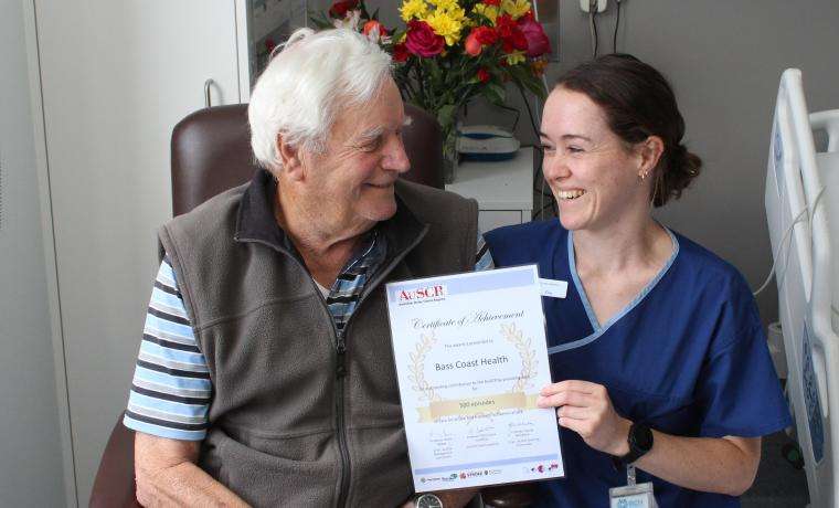 Stroke patient Errol Bradford with Bass Coast Health Stroke Coordinator Ella Roos and the certificate BCH received for providing data for 500 episodes of care for stroke. Errol is a patient at Wonthaggi Hospital’s Armitage House Sub-Acute Ward.