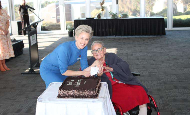 BCH Interim CEO Simone Alexander and Volunteer of 25 years, Candy Pile, cut a celebratory cake