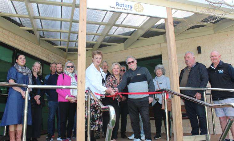 Gea Lovell, Rotary Club of Phillip Island and San Remo President, is joined by Kerryn Griffiths BCH Capital Works Clinical Liaison and Club member John Tennant, to cut the ribbon to officially open the Rotary Rehabilitation Courtyard at the Phillip Island Community Hospital in Cowes. Joining the celebrations are Rotarians, Bass Coast Health staff and builder Trevor Bowler from TS Constructions. 