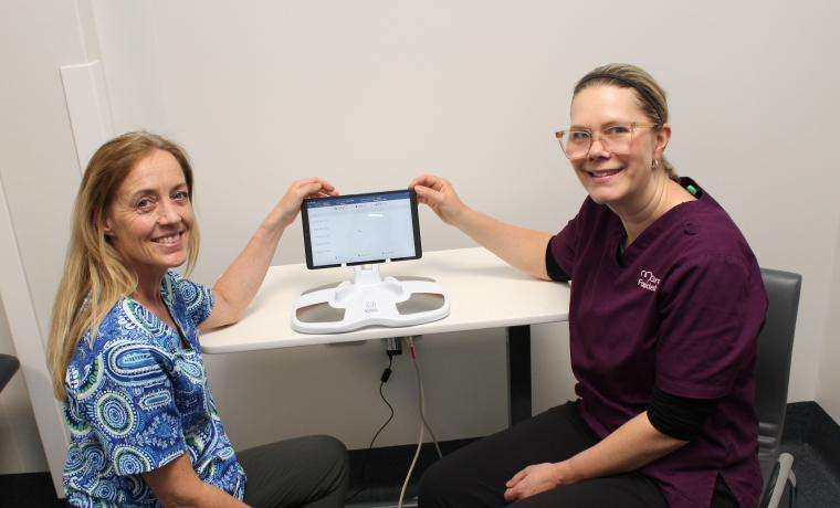 Bass Coast Health’s Lymphoedema Practitioner and Physiotherapist Michelle McMahon, left, with McGrath Cancer Care Nurse Taryn Robinson and the Sozo machine that measures fluid in a patient’s limbs. The machine was purchased for BCH by the Phillip Island Health Hub Auxiliary.