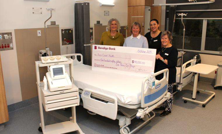 BCH Volunteer and Fundraising Manager Kerry Redmond, second from right, with members of the San Remo Opportunity Shop Auxiliary, from left, Helen Andrews, Marj Wagland and Caroline Talbot, and the upgraded fetal monitor and one of 20 beds the Auxiliary funded