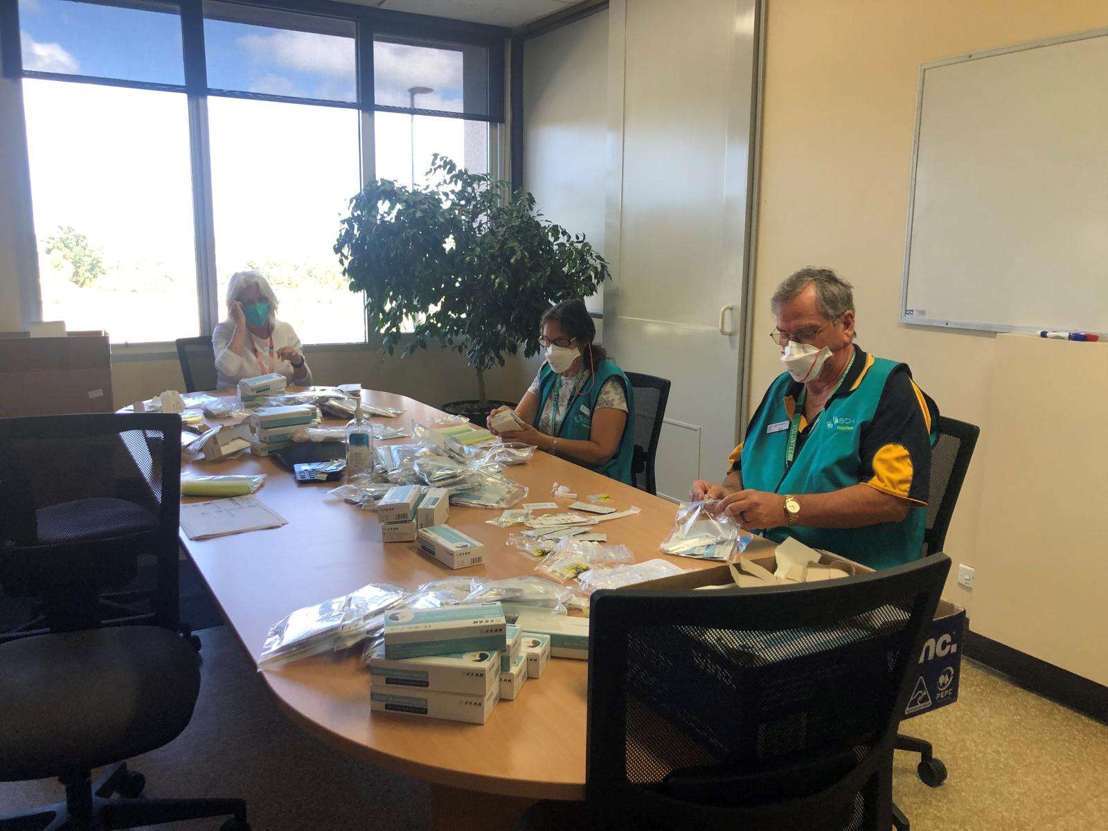 Volunteers assisting with RATs