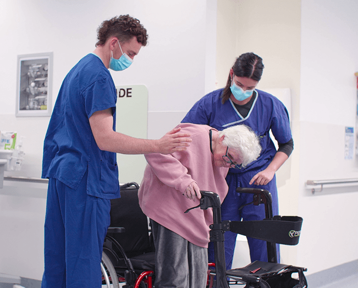 Occupational Therapists assist a consumer ambulating