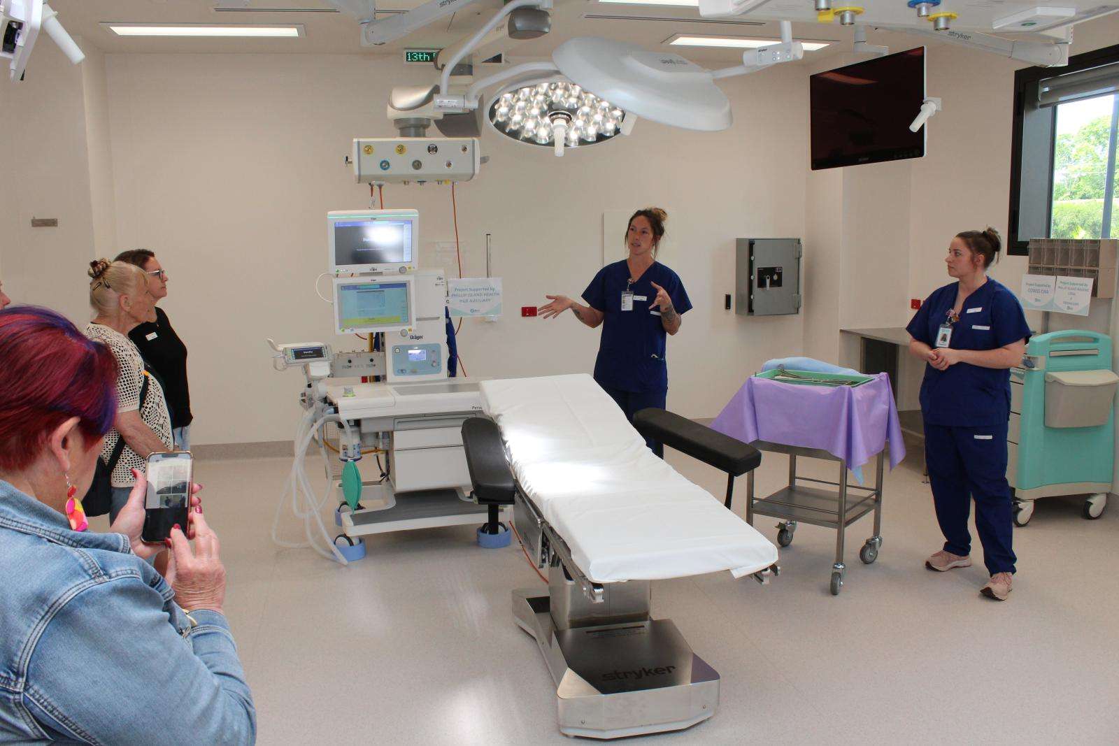Theatre Registered Nurse Alyssa Hughes and Scrub Scout Bec Toronyi inform a tour group of the state-of-the-art technology in the two operating theatres.