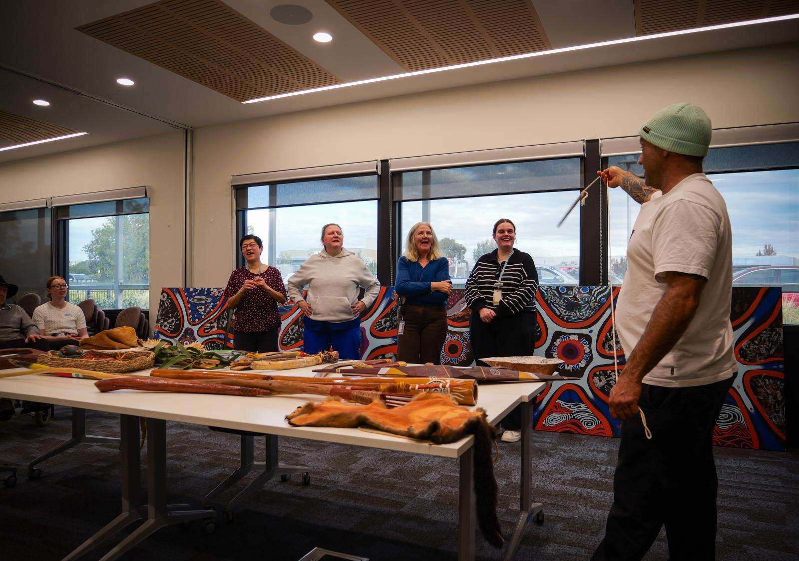 First Nations artist Steve Parker demonstrates traditional First Nations tools and instruments to staff at Leongatha Memorial Hospital.
